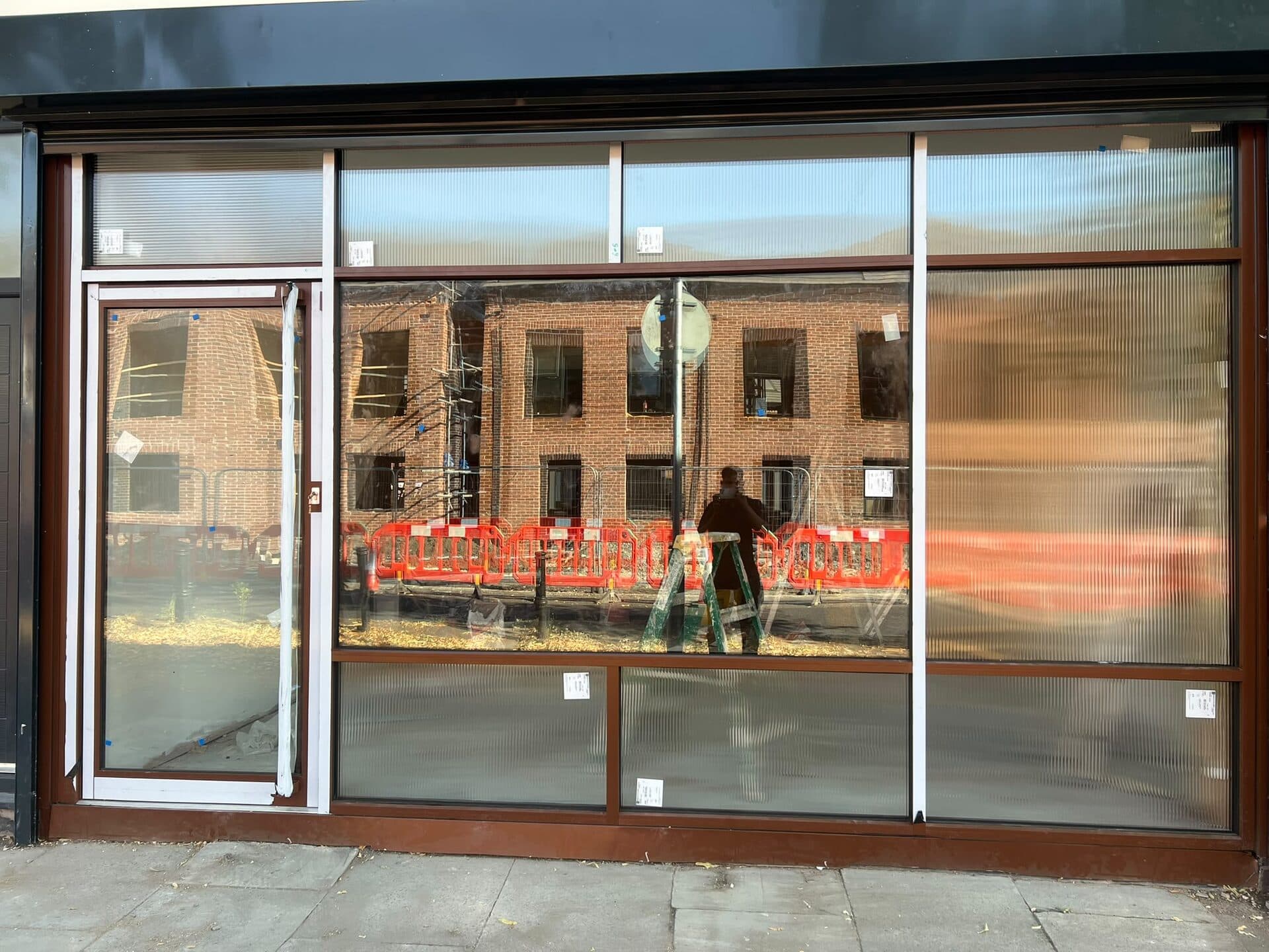 Bronze aluminium shopfront with full-height glazing